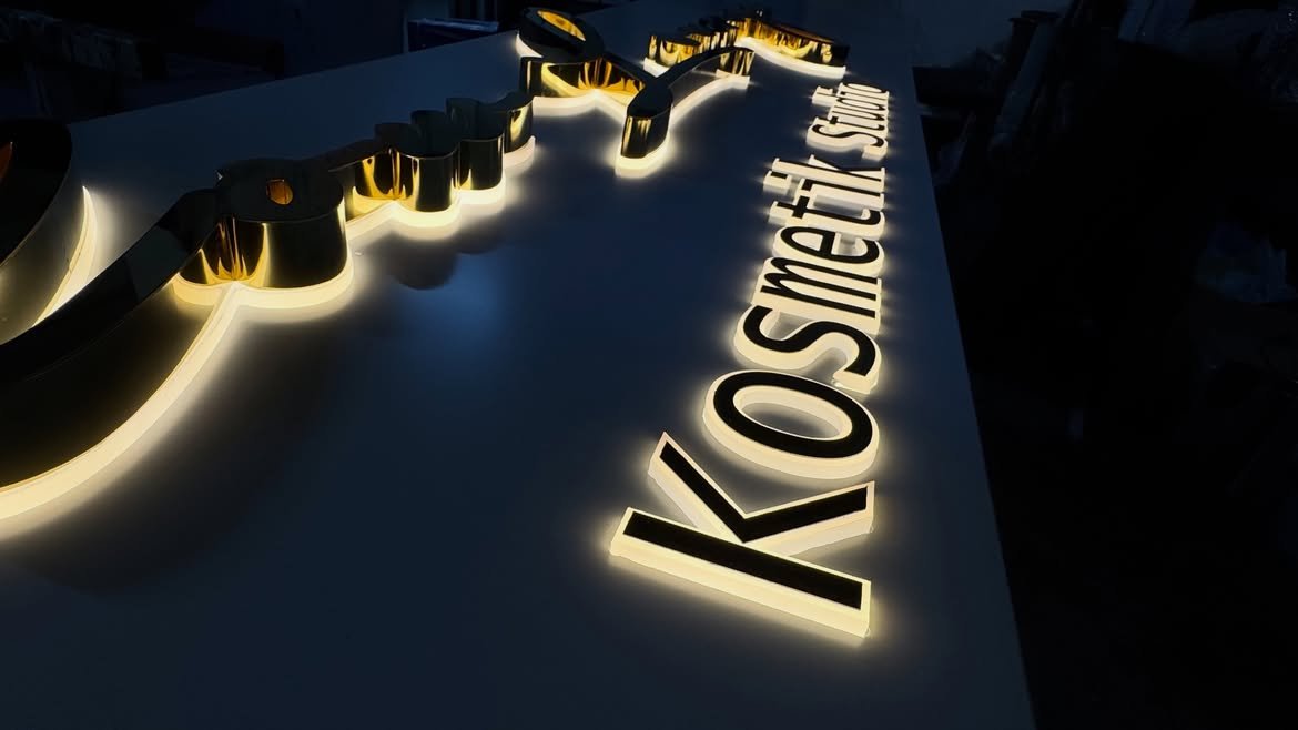 : 3D polished mirror gold stainless steel side-lit LED letters custom fabricated for corporate reception wall in Kololo, Kampala, Uganda.