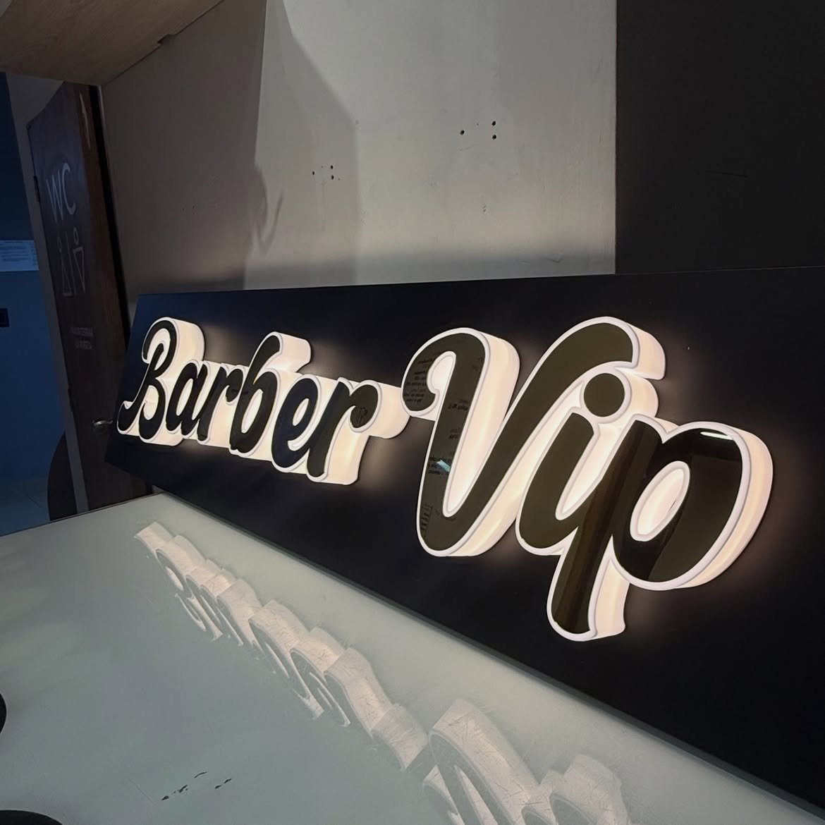 3D script channel letters with glowing acrylic side borders mounted on black composite tray in Acacia Mall, Kisementi, Kampala, Uganda.